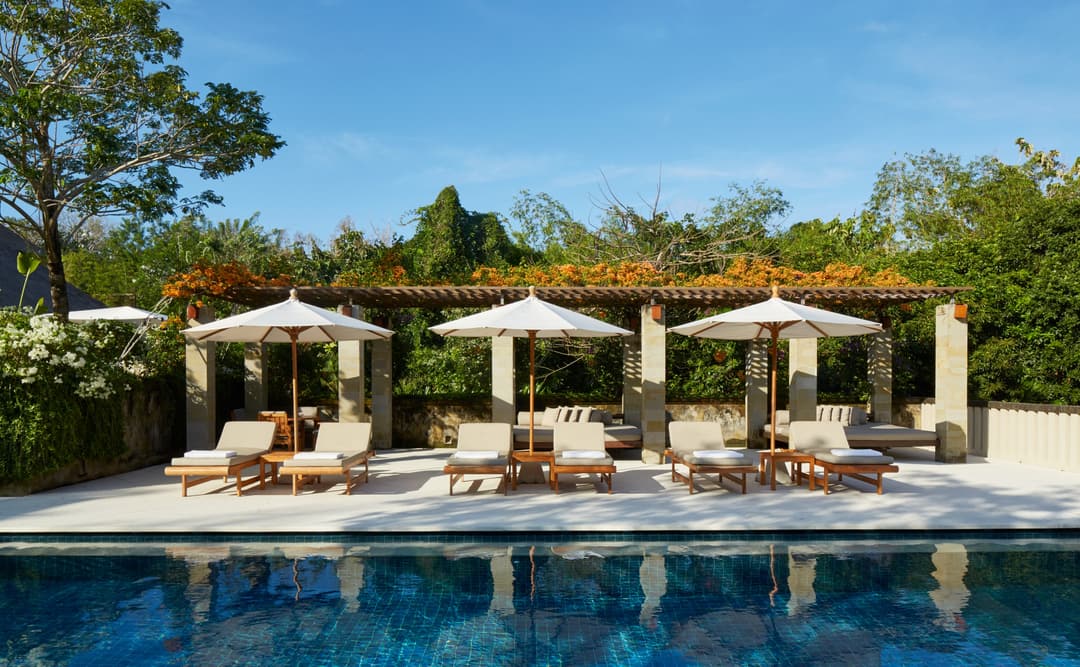 Six-bedroom villa with pool and pergola-shaded lounging areas at Aman Villas at Nusa Dua