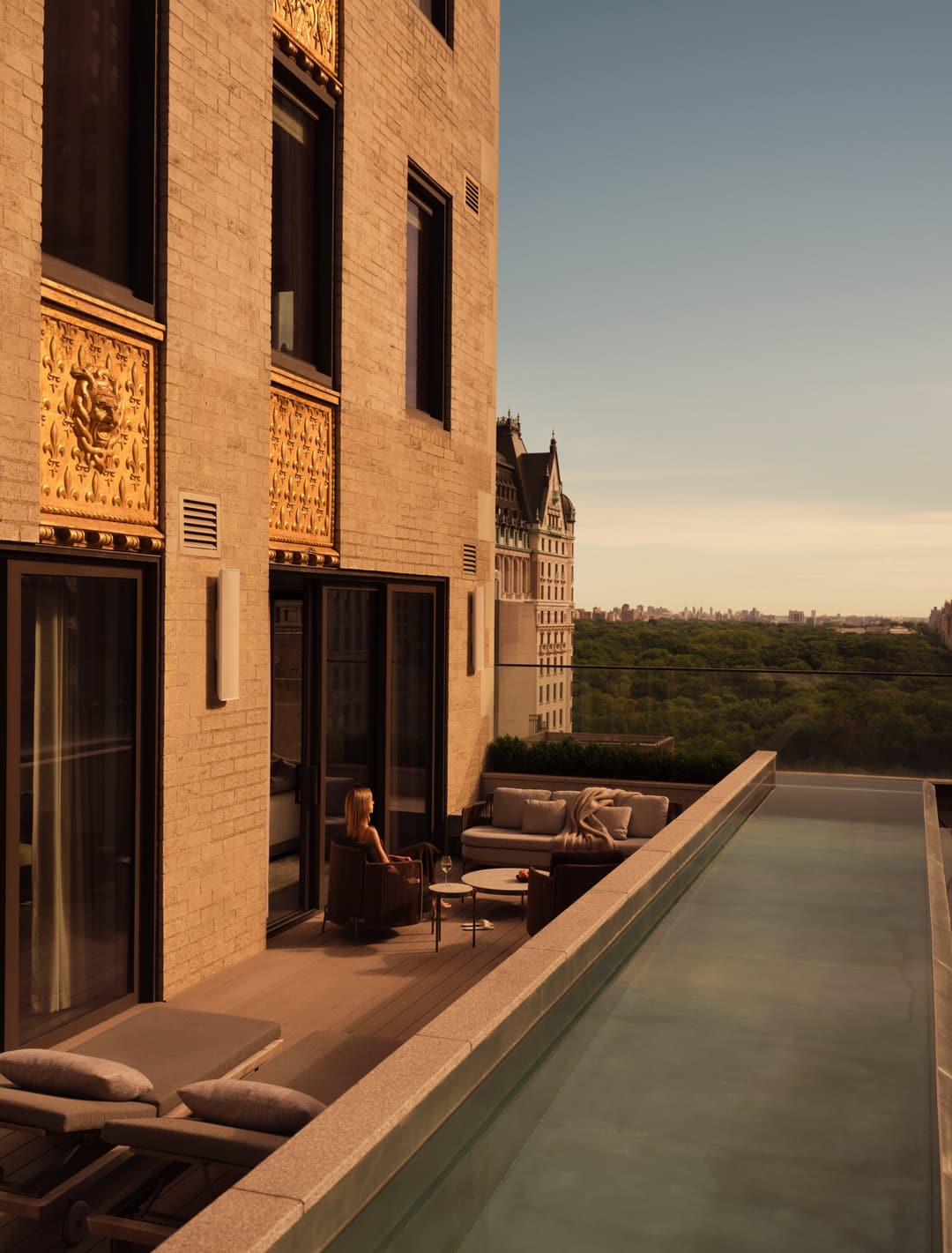 Three-bedroom home at Aman New York with pool terrace at sunset.