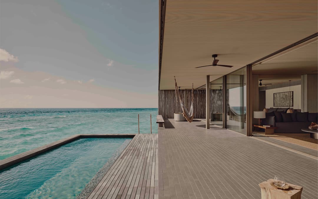 Deck and pool overlook turquoise ocean, Patina Maldives, Fari Islands, North Male Atoll (Fari Islands)