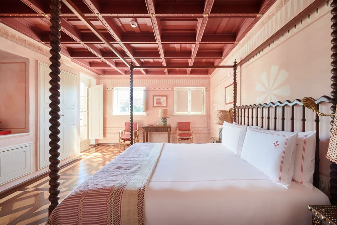 Cozy lounge with armchair and fireplace at a boutique hotel in Melides, Portugal, Vermelho Melides