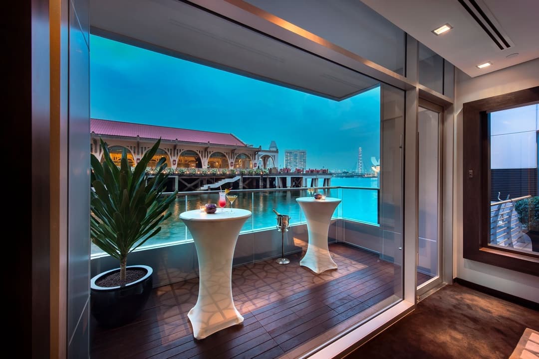 Balcony view with pod tables overlooking waterfront at The Fullerton Bay Singapore, The Fullerton Bay Hotel Singapore