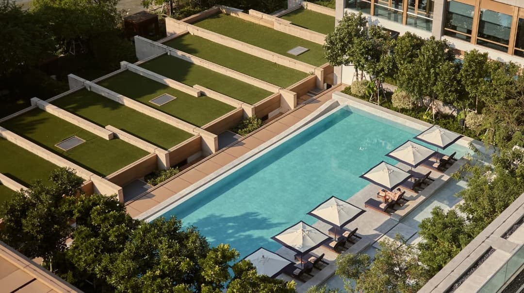 Swimming pool and lawn terraces by the river, Capella Bangkok