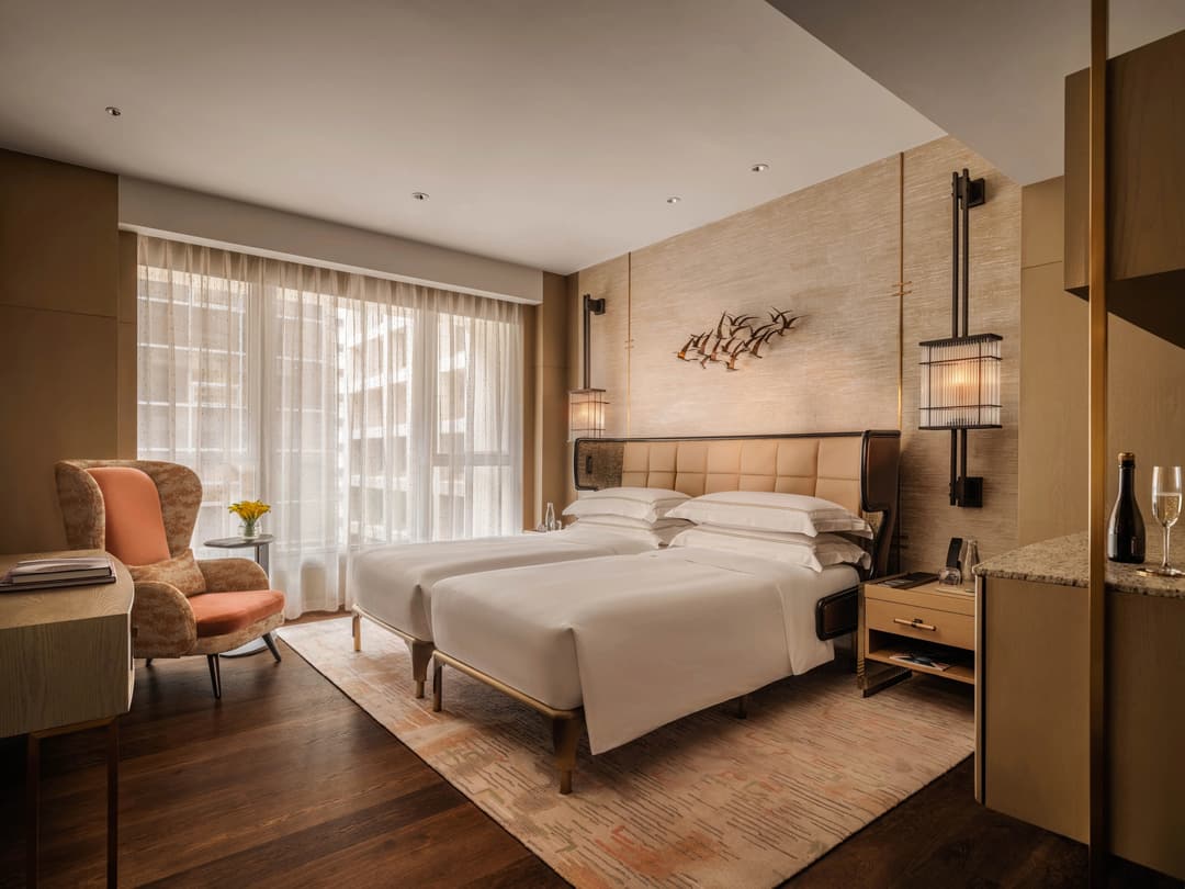 Luxury hotel bedroom with a king-sized bed, side tables, armchair, and sheer window drapes, The Landmark Mandarin Oriental, Hong Kong