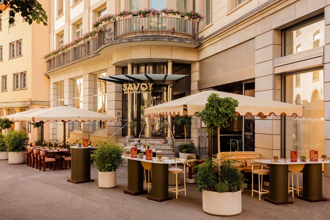 Outdoor terrace with umbrellas and high tables at Mandarin Oriental Savoy, Zurich
