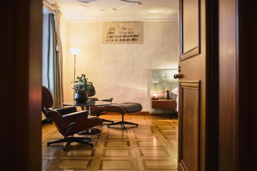 Eames lounge chair and ottoman in a wood-panelled room at Widder Hotel, Zurich