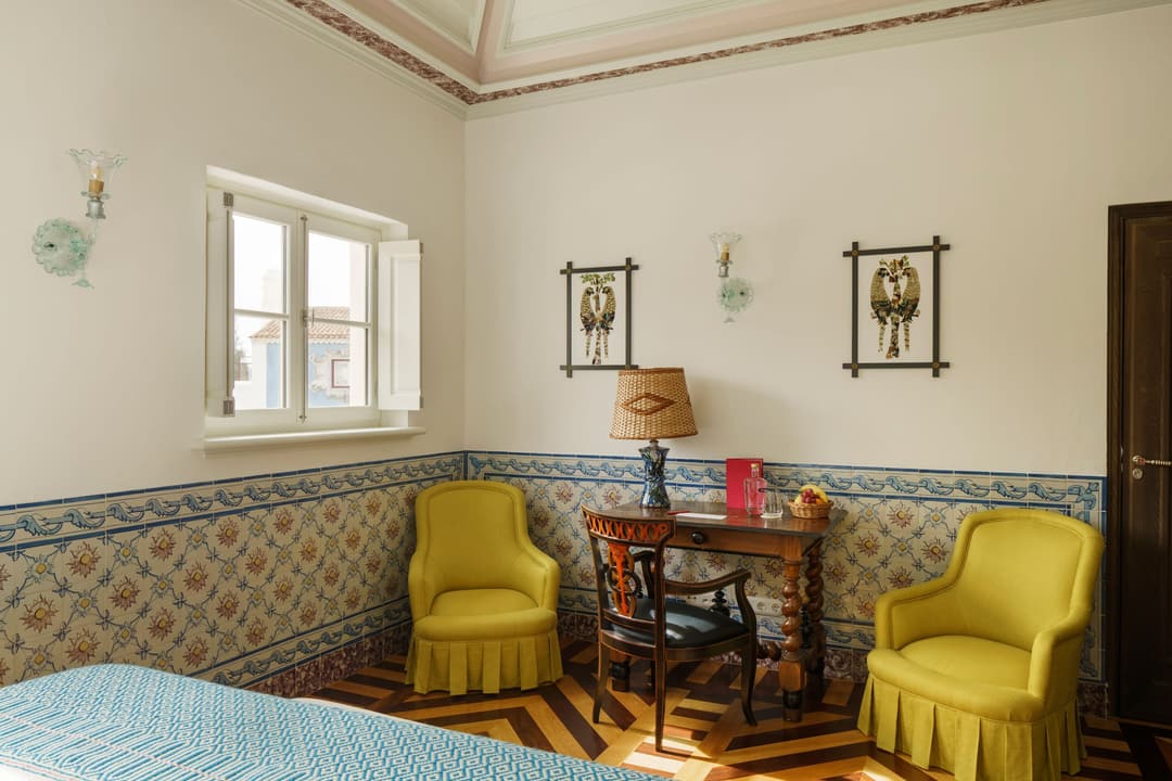 Bright yellow armchairs in a cozy lounge at a 5-star boutique hotel in Melides, Portugal, Vermelho Melides