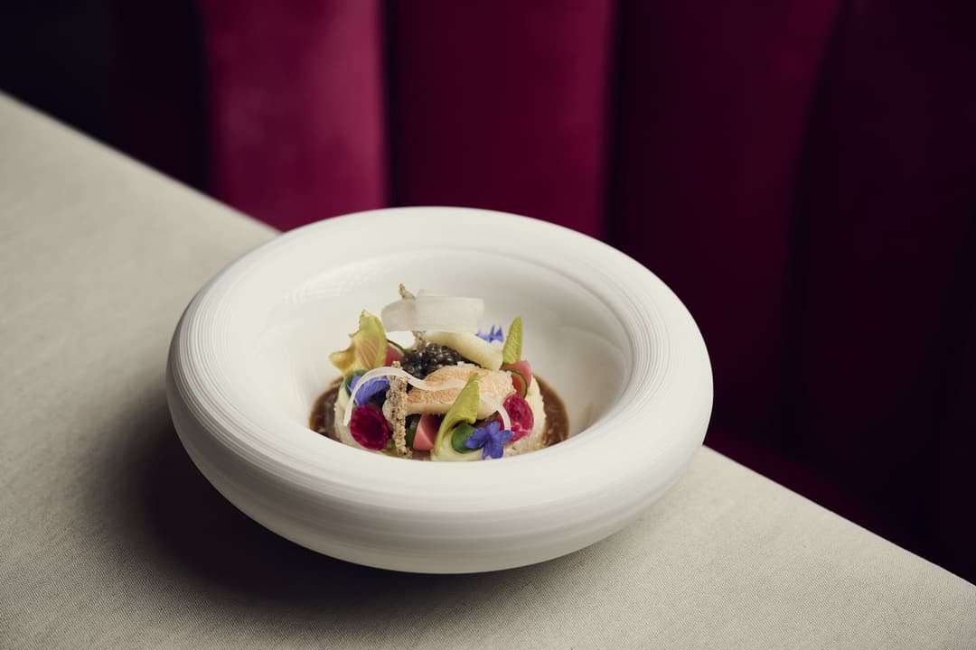 Plated dish with caviar and edible flowers at Widder Hotel, Zurich