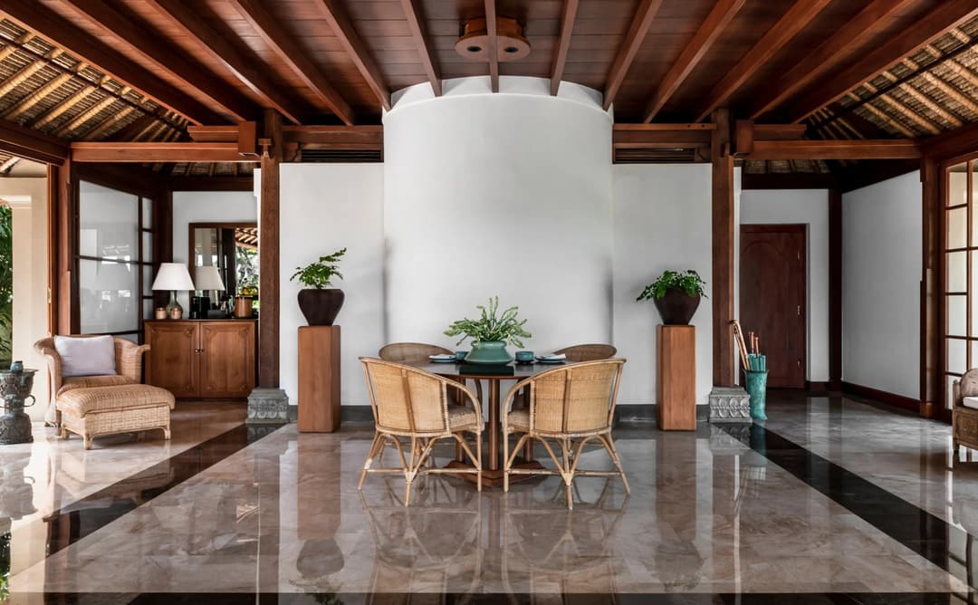 Ayung Suite at Amandari with polished stone floor, wooden ceiling beams, and round dining table overlooking river valley
