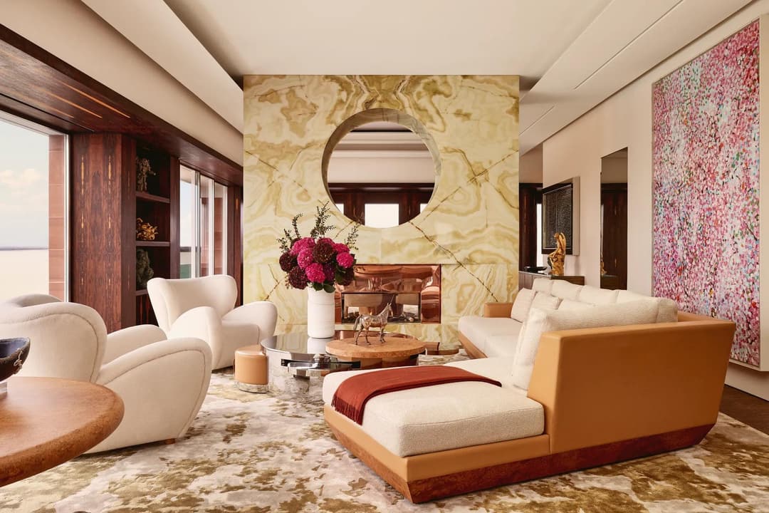 Contemporary living room at Claridge’s with a marble fireplace, cream sofas, modern artwork, and warm natural light, Claridge's