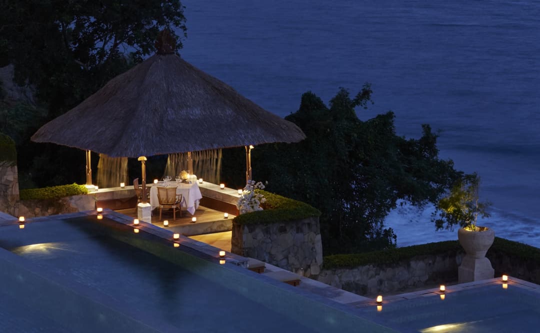 Bhoga Samatra dining venue at Amankila illuminated at dusk overlooking the ocean, Manggis (East Bali)