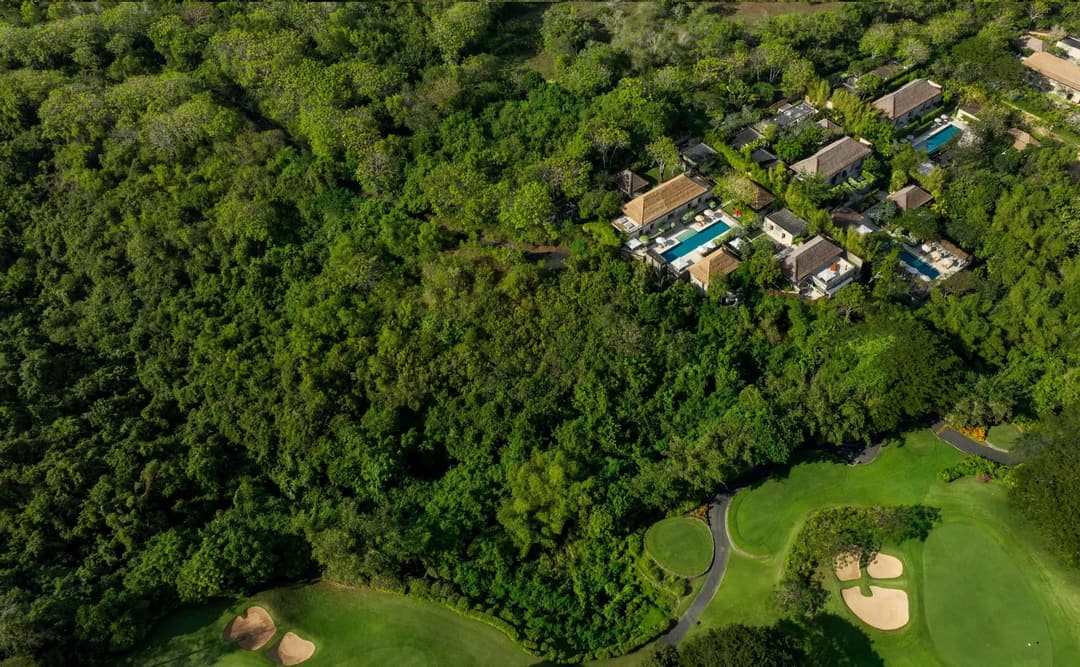 Aerial view of Aman Villas at Nusa Dua nestled amongst tropical forest and manicured grounds, Indonesia