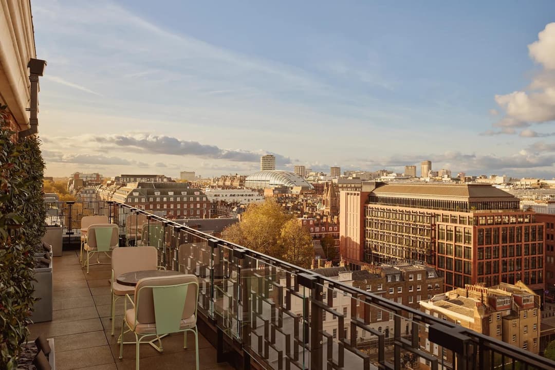Rooftop terrace at Claridge’s with café tables overlooking the London skyline at sunset, Claridge's