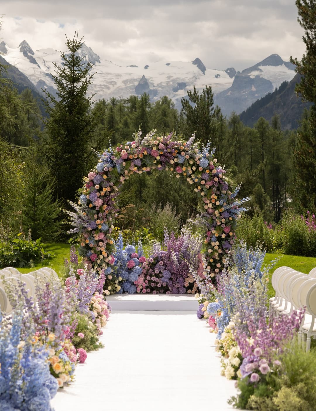 Grand Hotel Kronenhof garden wedding setup with white carpet, flowers and Roseg Glacier views, Pontresina